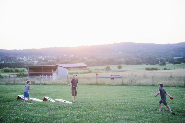 boys playing cornhole