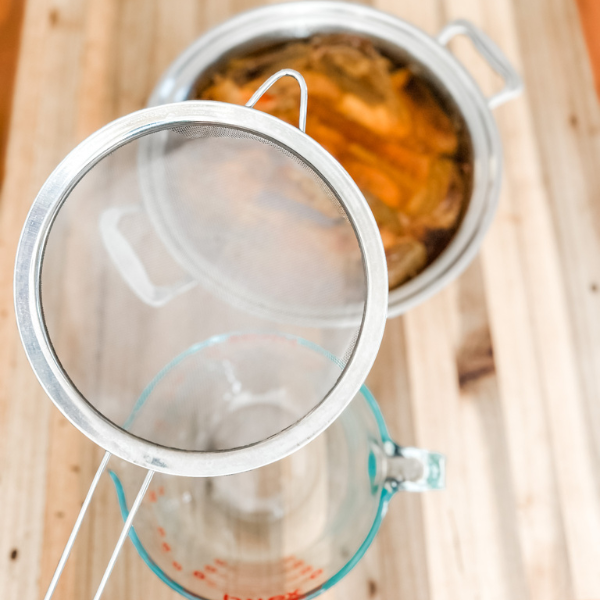 Straining Homemade Bone Broth | Roots & Boots
